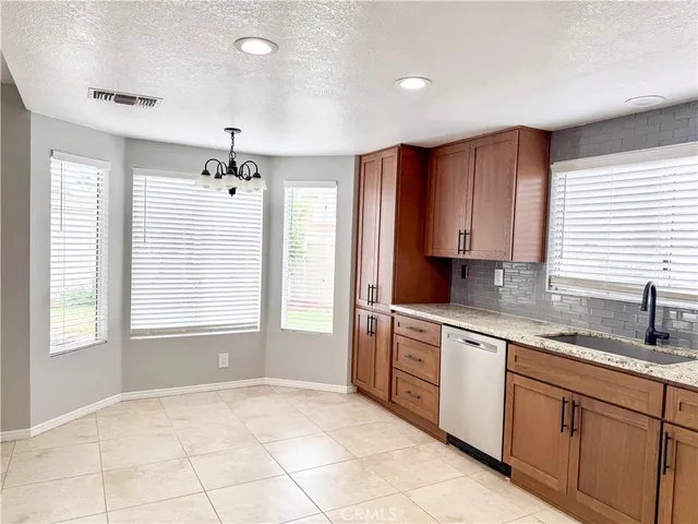 a kitchen with a sink window and cabinets