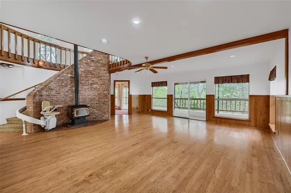 a view of a livingroom with furniture and a floor to ceiling window