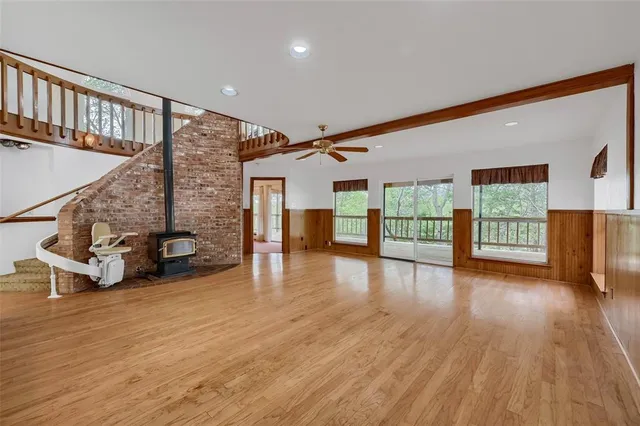 a view of a livingroom with furniture and a floor to ceiling window