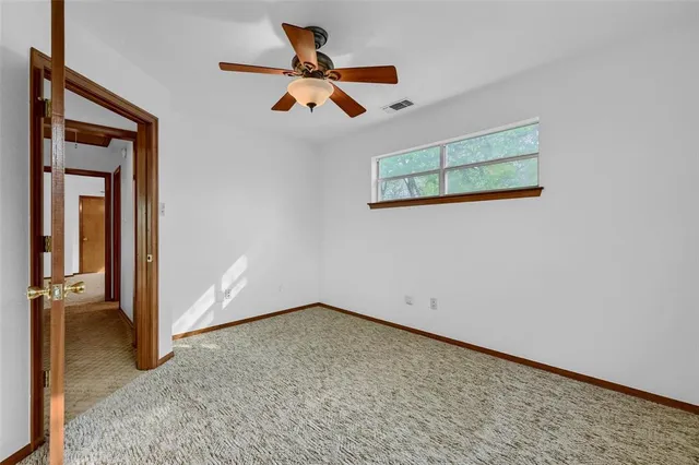a bathroom with a toilet a sink and a window