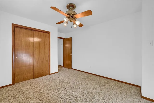 a view of empty room with wooden floor and windows