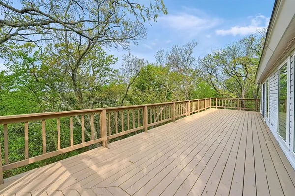 a view of backyard with a deck and wooden floor