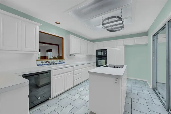 a kitchen with a sink cabinets and window