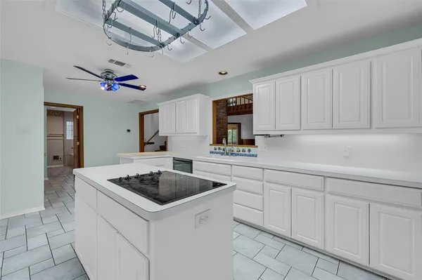 a kitchen with cabinets appliances and a counter top space
