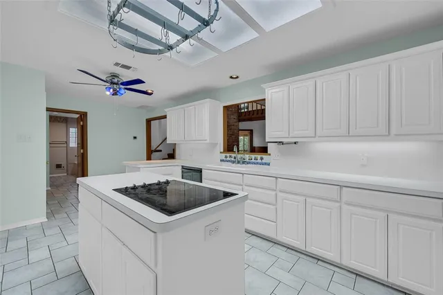 a kitchen with cabinets appliances and a counter top space