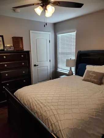 a bedroom with a bed and a chandelier