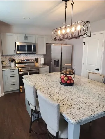 a kitchen with granite countertop wooden cabinets and a sink