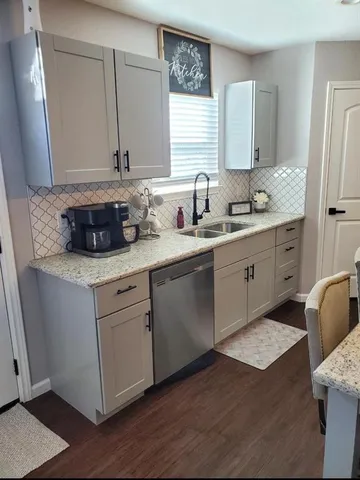 a kitchen with kitchen island a counter space a sink stove and cabinets