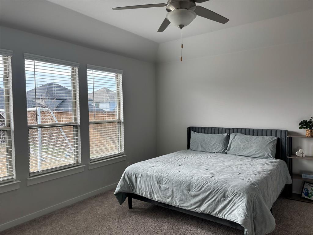 2029 Dovedale Drive Forney, TX 75126 - Photo 9 of 18 a bed sitting in a bedroom next to a window