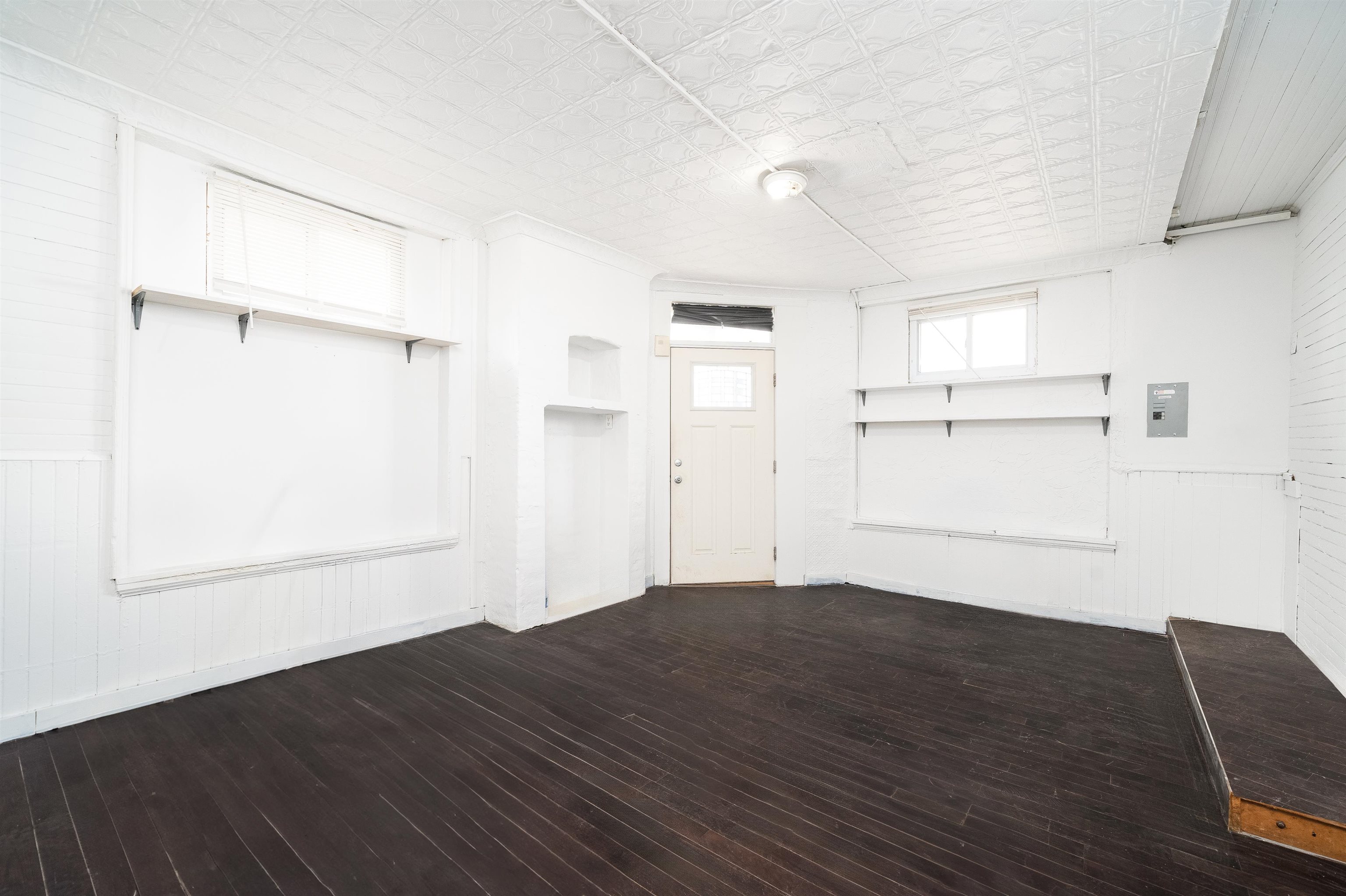 74 Colgate Street, Unit 1 Jersey City, NJ 07302 - Photo 3 of 12 an empty room with wooden floor cabinet and windows