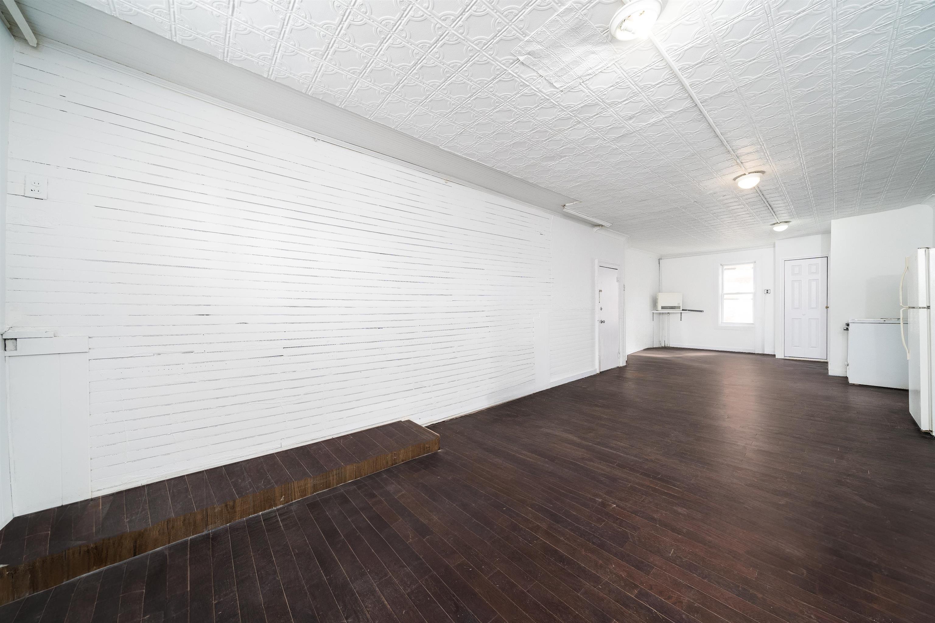 74 Colgate Street, Unit 1 Jersey City, NJ 07302 - Photo 5 of 12 a view of empty room with wooden floor