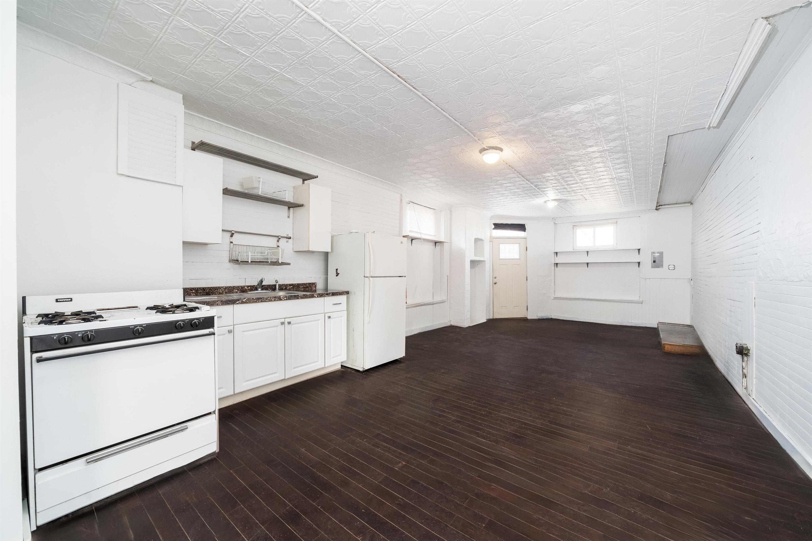 74 Colgate Street, Unit 1 Jersey City, NJ 07302 - Photo 7 of 12 a kitchen with stainless steel appliances a refrigerator and a stove top oven