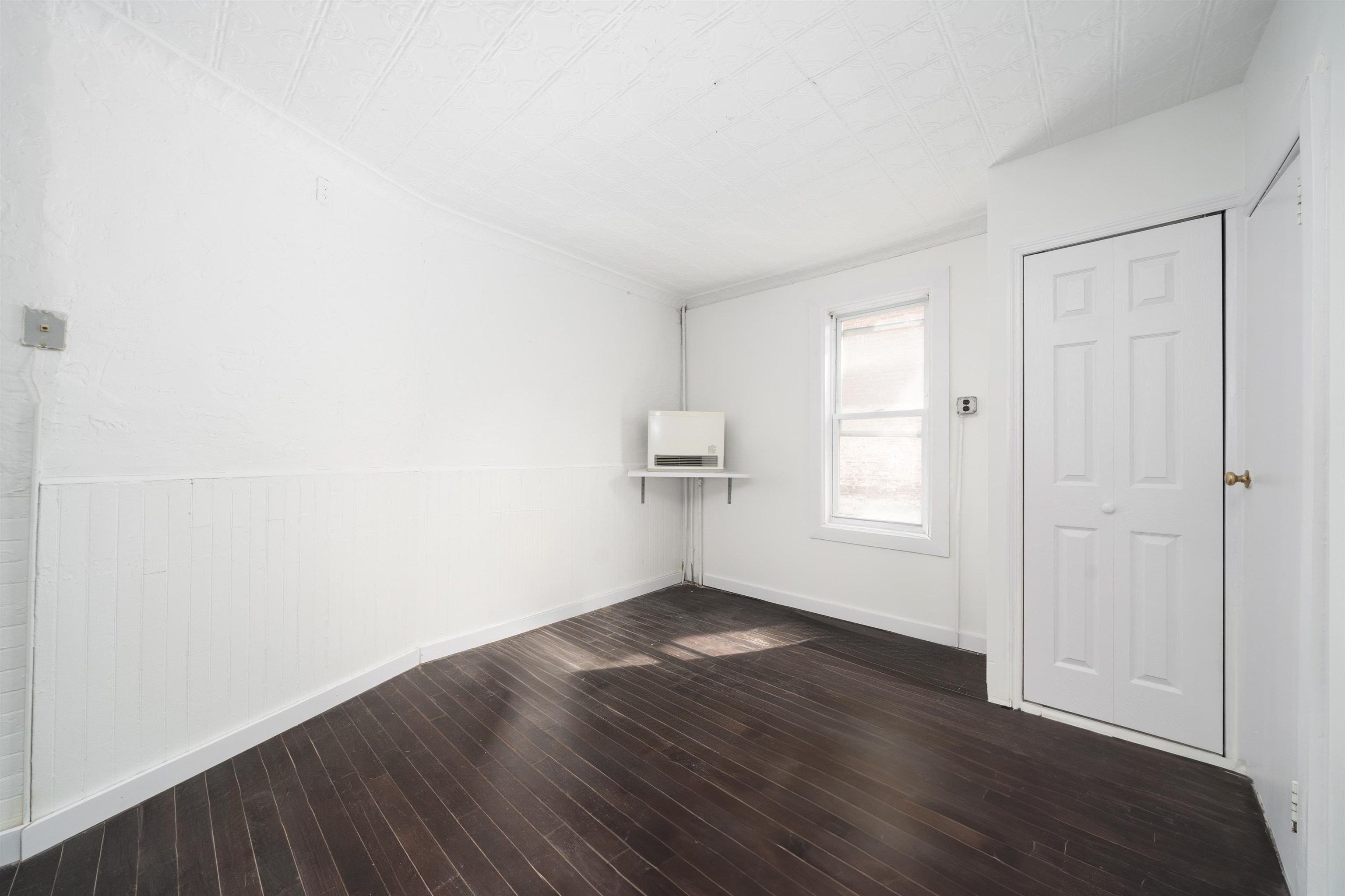 74 Colgate Street, Unit 1 Jersey City, NJ 07302 - Photo 8 of 12 an empty room with wooden floor and windows