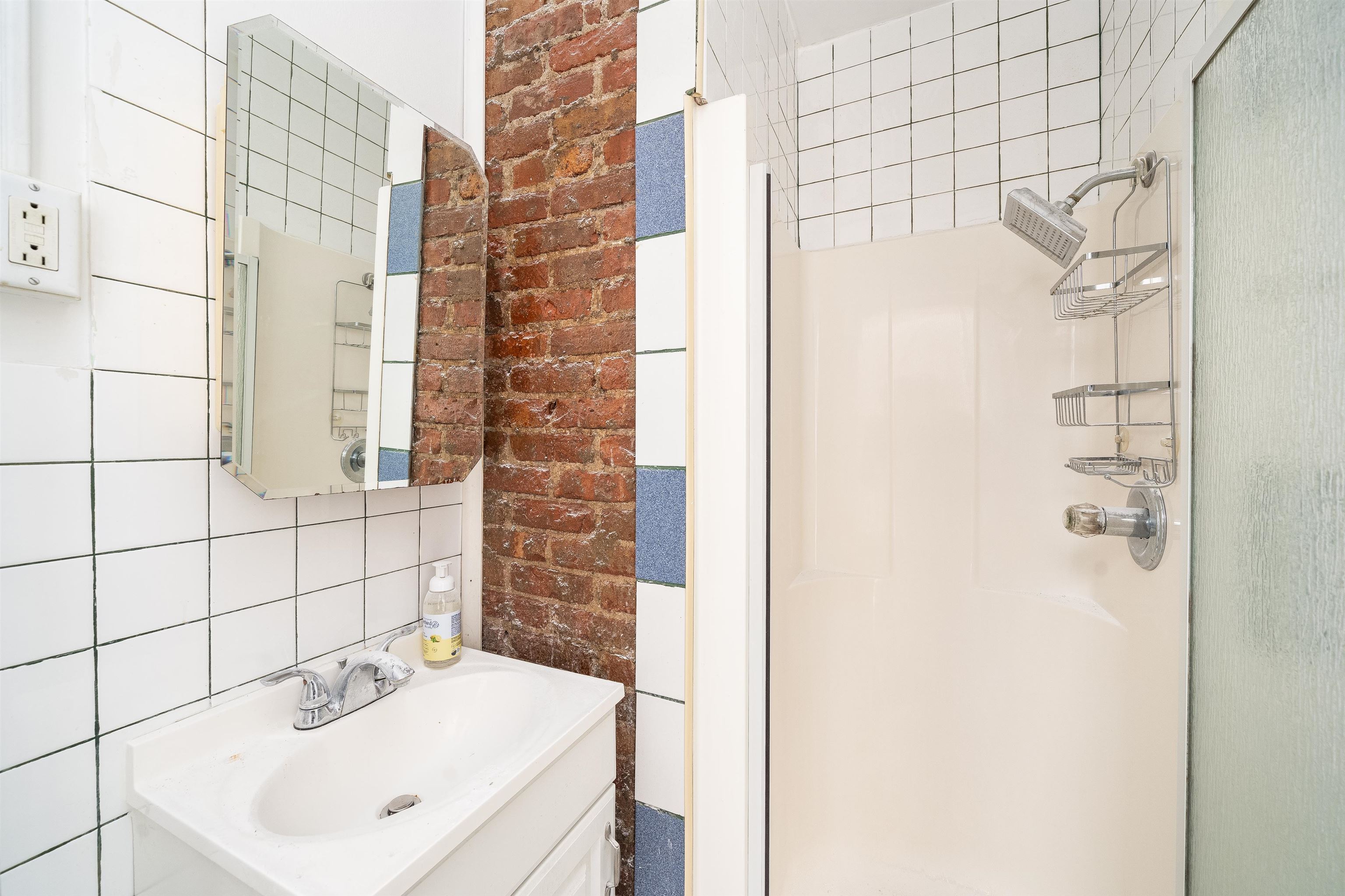 74 Colgate Street, Unit 1 Jersey City, NJ 07302 - Photo 10 of 12 a bathroom with a sink and a mirror