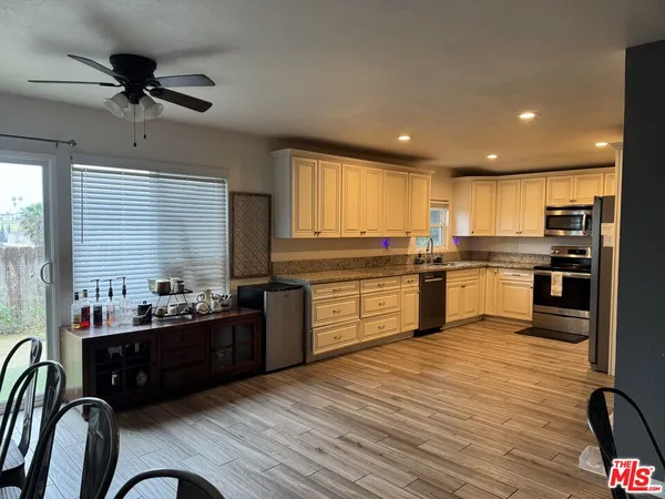 a kitchen with a sink stainless steel appliances and window
