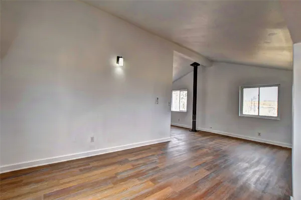 a view of hallway with stairs and wooden floor
