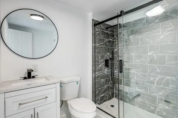 a view of hallway with mirror and furniture