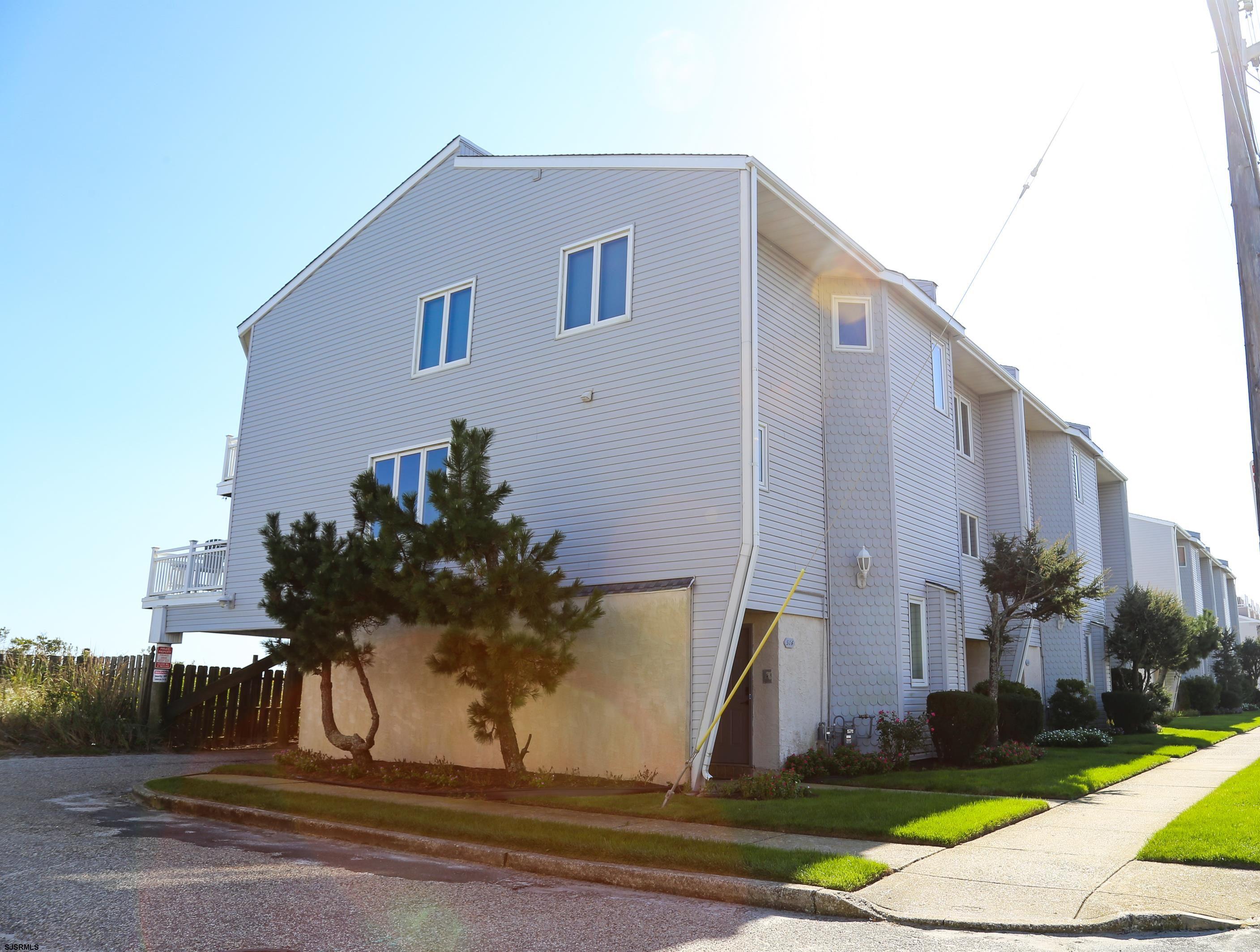 512 East Brigantine Avenue, Unit 512 Brigantine, NJ 08203 - Photo 12 of 46 a front view of a house with garden
