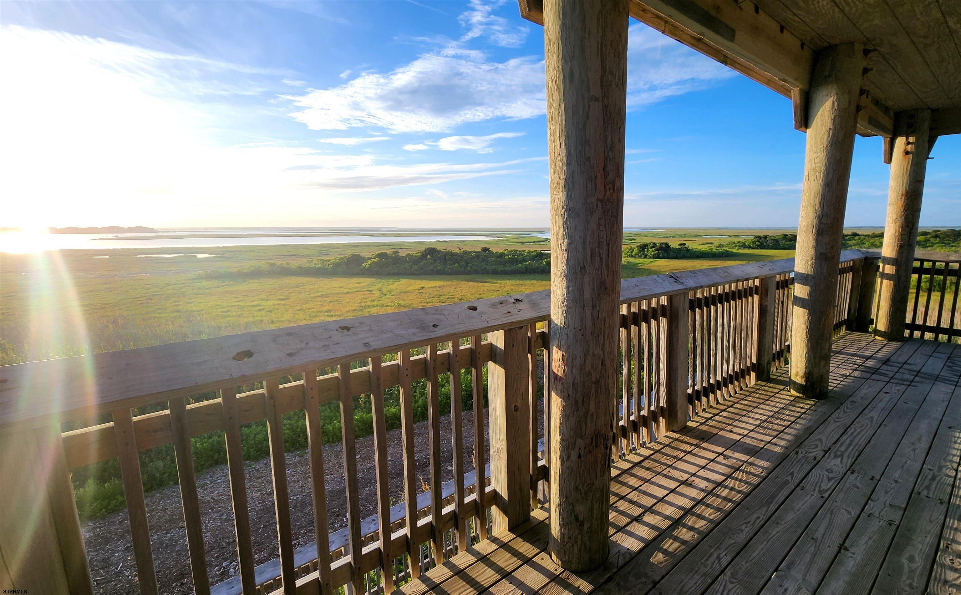 512 East Brigantine Avenue, Unit 512 Brigantine, NJ 08203 - Photo 35 of 46 a view of a balcony with wooden floor next to a yard