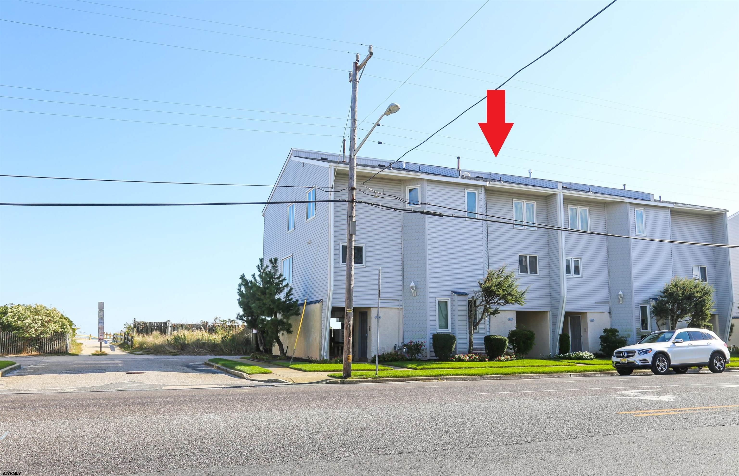 512 East Brigantine Avenue, Unit 512 Brigantine, NJ 08203 - Photo 7 of 46 a front view of a building with small garden