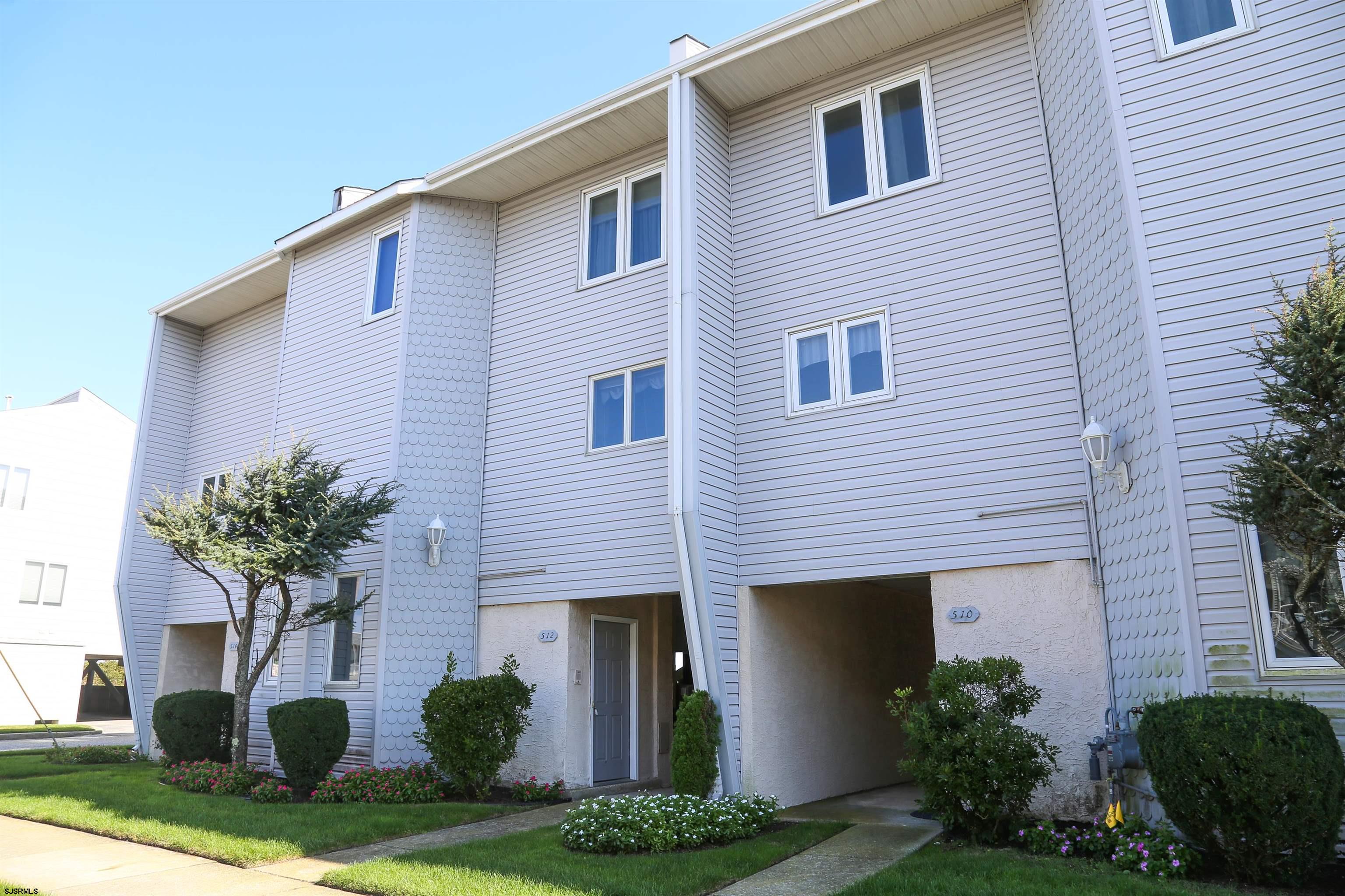 512 East Brigantine Avenue, Unit 512 Brigantine, NJ 08203 - Photo 10 of 46 a front view of a house with garden