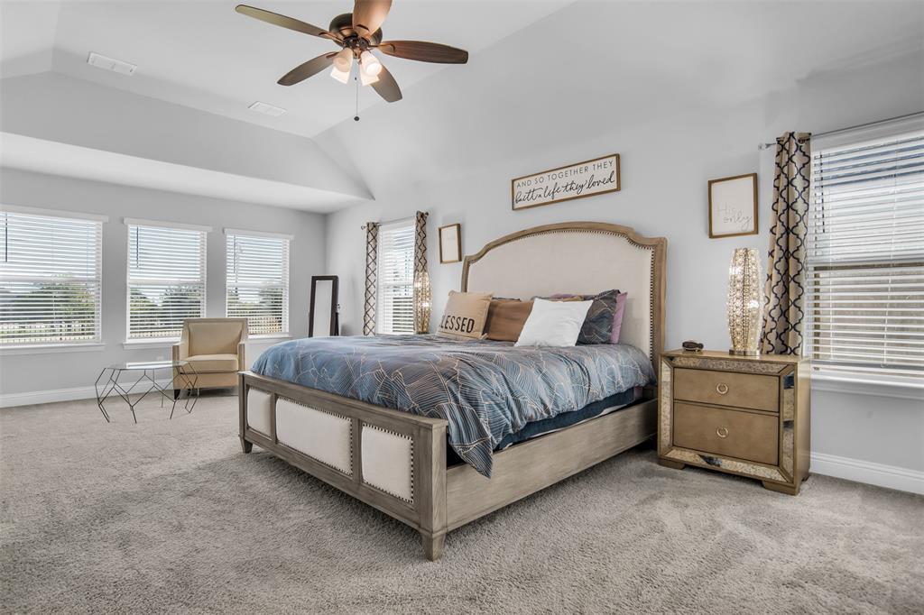 1566 Harrison Circle Waxahachie, TX 75165 - Photo 13 of 38 a spacious bedroom with a bed a table and large window