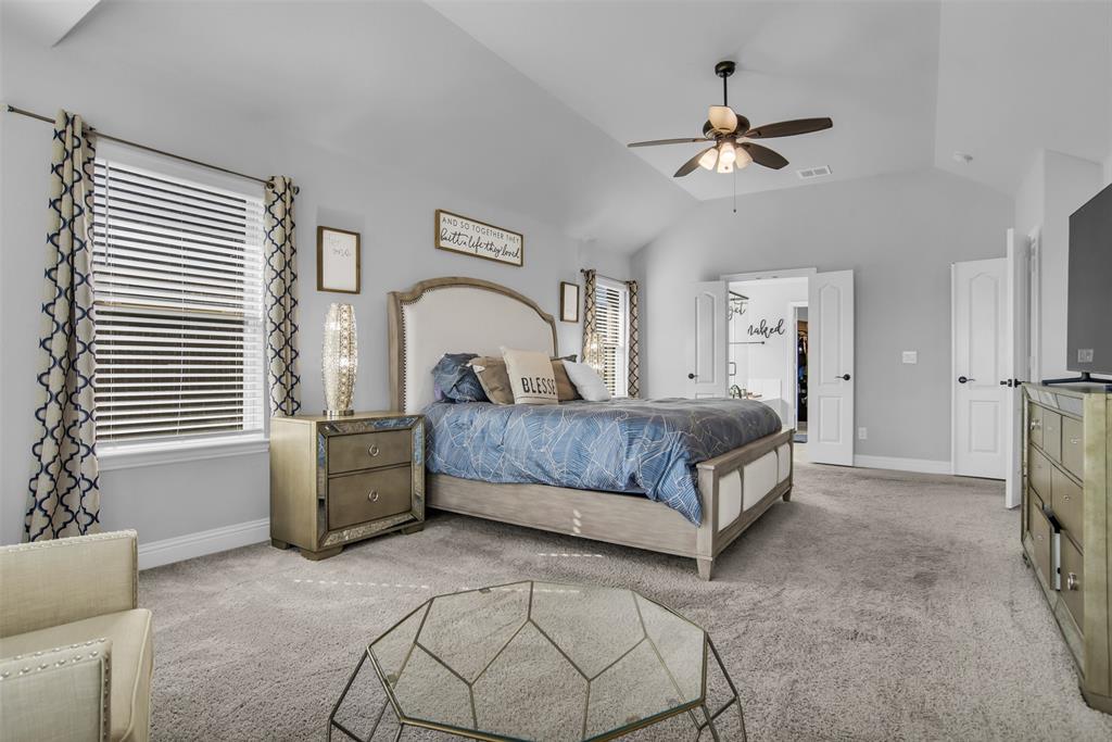 1566 Harrison Circle Waxahachie, TX 75165 - Photo 15 of 38 a bedroom with a large bed and a chandelier