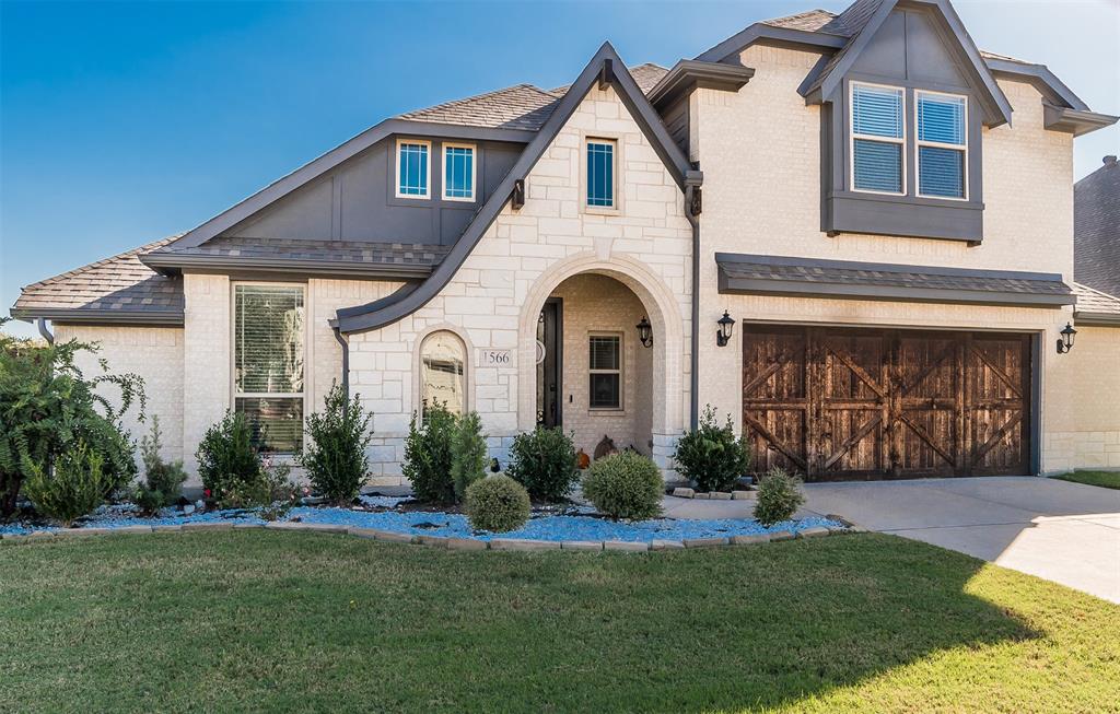1566 Harrison Circle Waxahachie, TX 75165 - Photo 2 of 38 a front view of a house with a garden