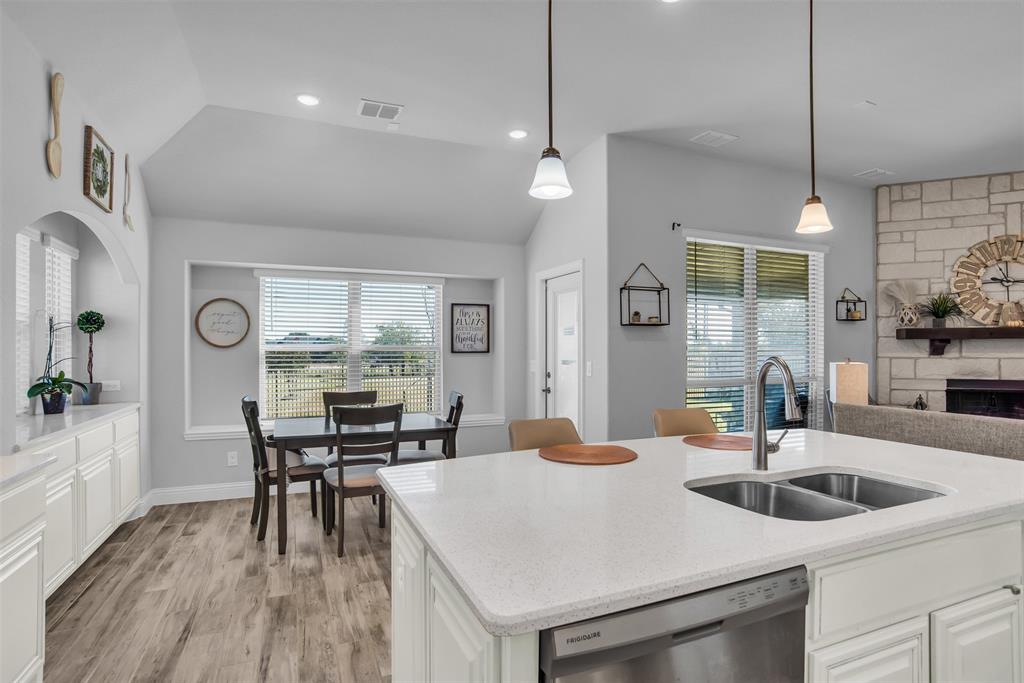 1566 Harrison Circle Waxahachie, TX 75165 - Photo 26 of 38 a kitchen with a table chairs refrigerator and stove