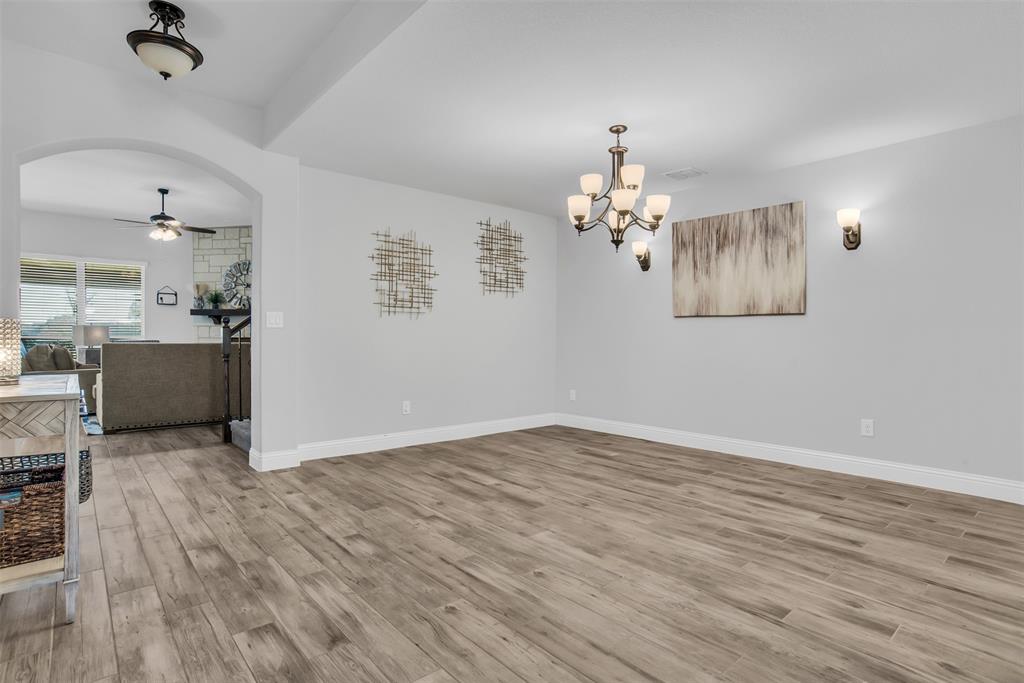 1566 Harrison Circle Waxahachie, TX 75165 - Photo 7 of 38 wooden floor in an empty room with a window