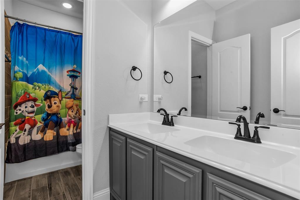 1566 Harrison Circle Waxahachie, TX 75165 - Photo 10 of 38 a bathroom with a sink a vanity and a mirror