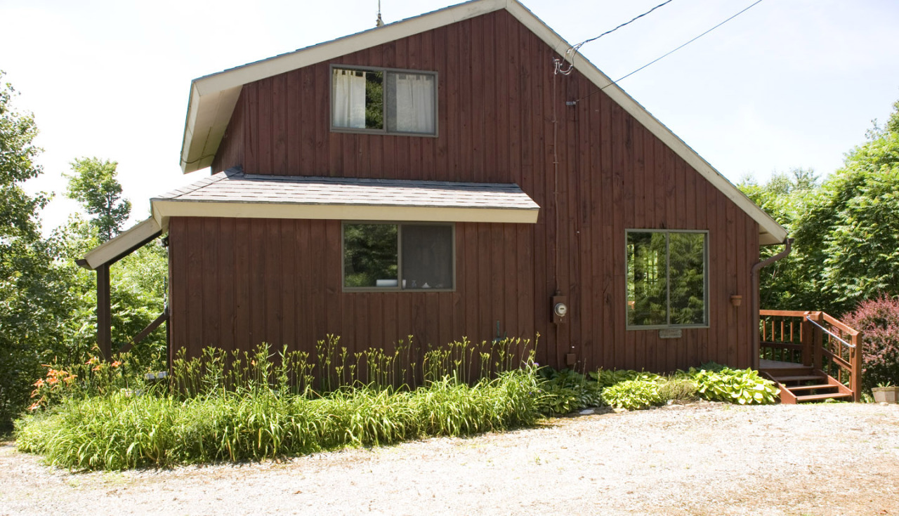 77 Stebbins Road Otis, MA 01253 - Photo 1 of 17 a front view of a house with garden
