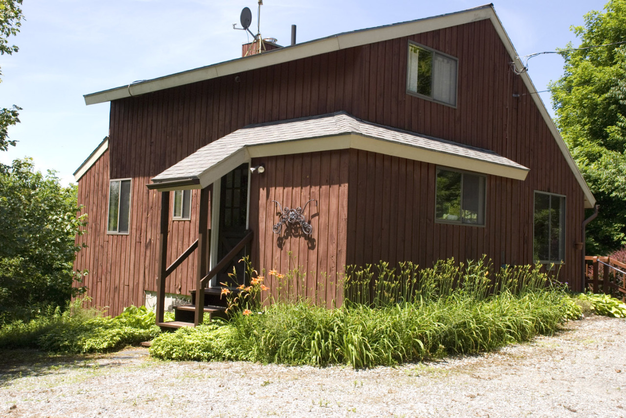 77 Stebbins Road Otis, MA 01253 - Photo 2 of 17 a front view of a house with garden
