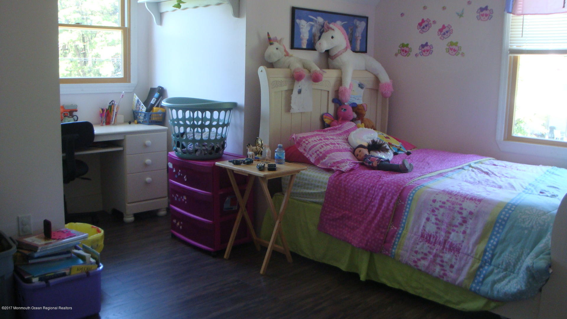 2323 Maple Road Forked River, NJ 08731 - Photo 14 of 23 a bedroom with a bed and wooden floor