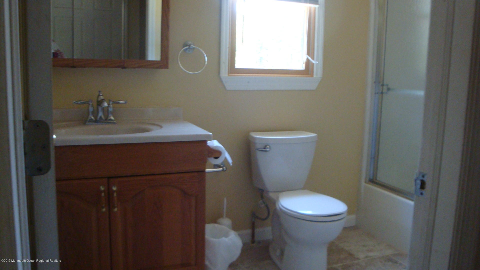 2323 Maple Road Forked River, NJ 08731 - Photo 15 of 23 a bathroom with a toilet a sink and a window