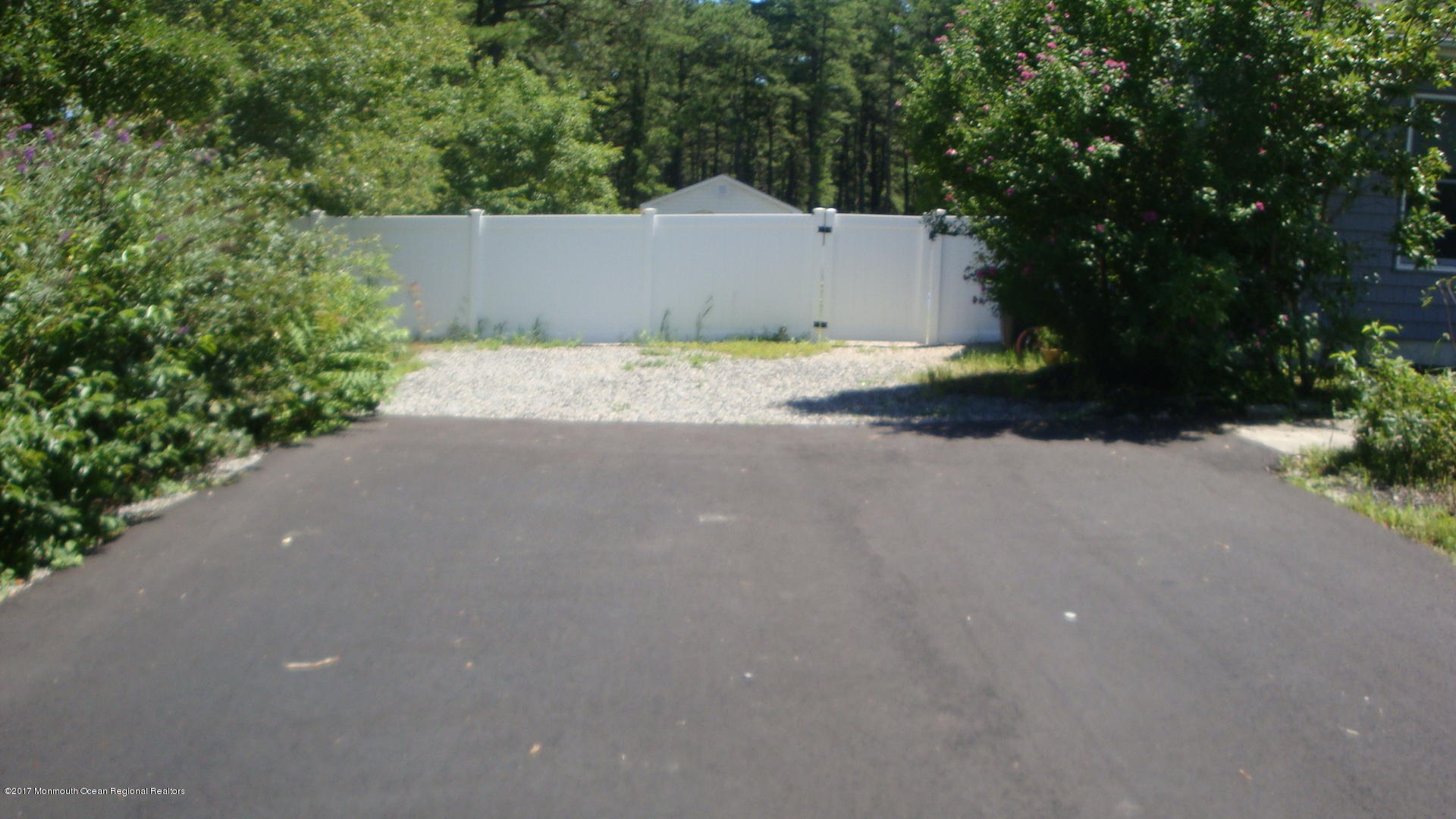 2323 Maple Road Forked River, NJ 08731 - Photo 17 of 23 a backyard of a house with plants and trees