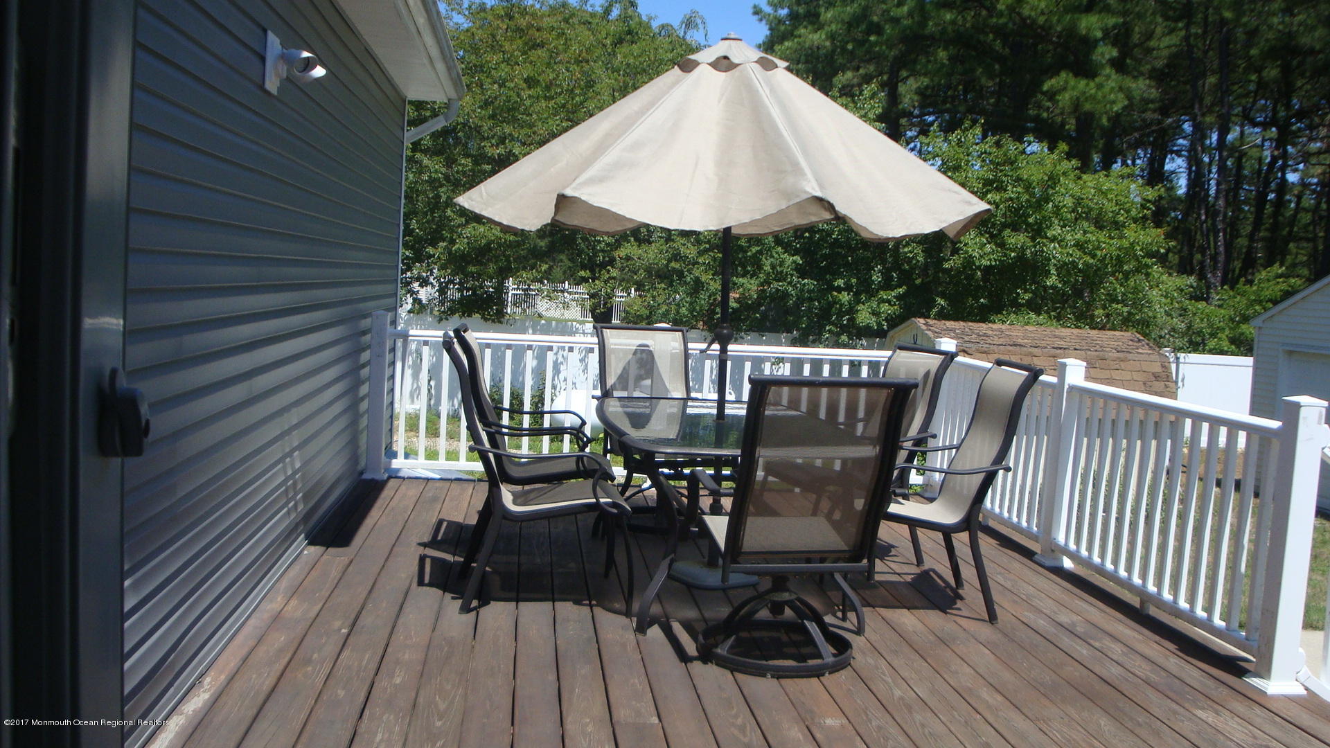 2323 Maple Road Forked River, NJ 08731 - Photo 19 of 23 a view of deck with furniture and barbeque oven in a backyard