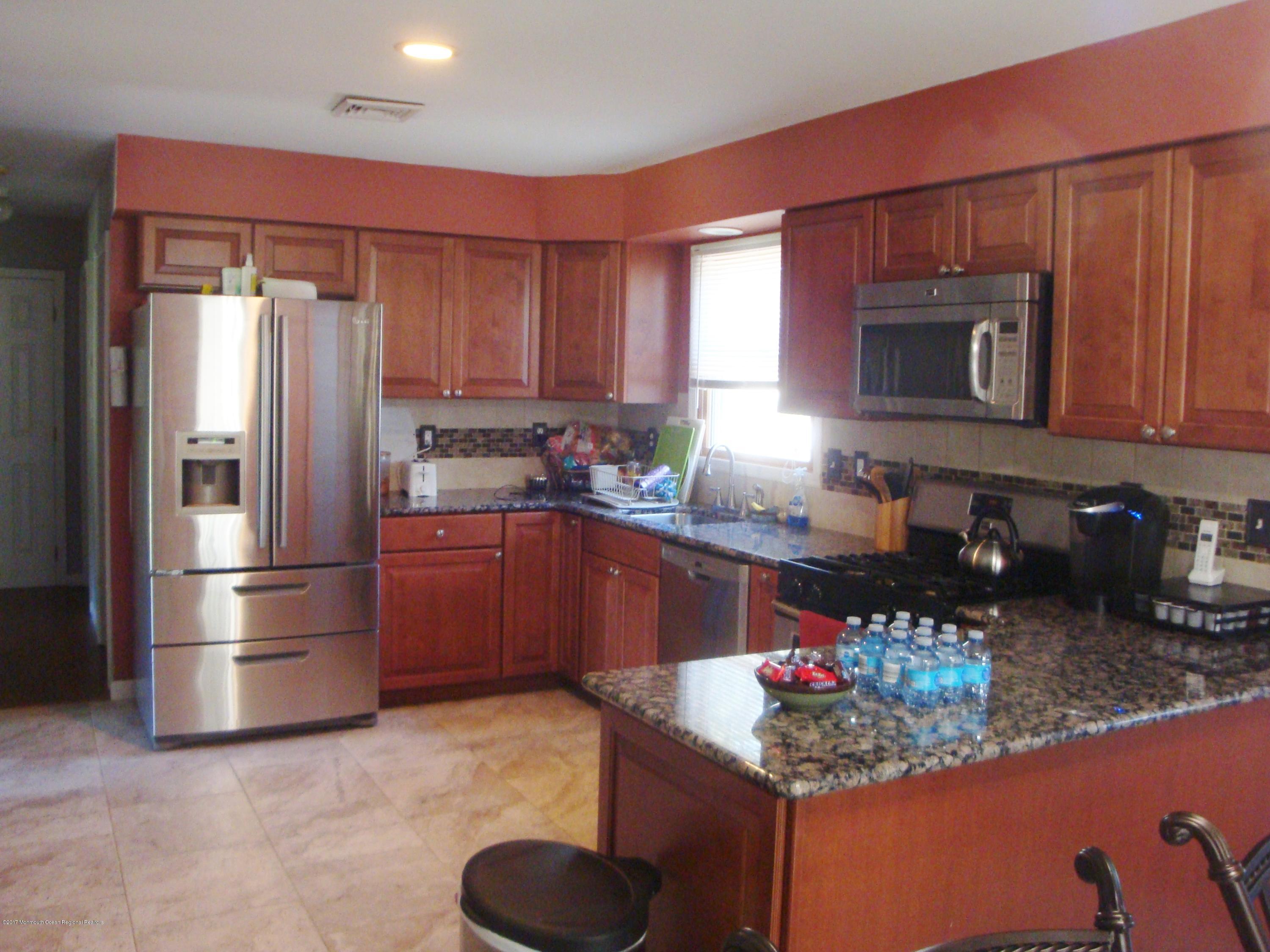 2323 Maple Road Forked River, NJ 08731 - Photo 2 of 23 a kitchen with stainless steel appliances granite countertop a refrigerator stove top oven a sink and dishwasher