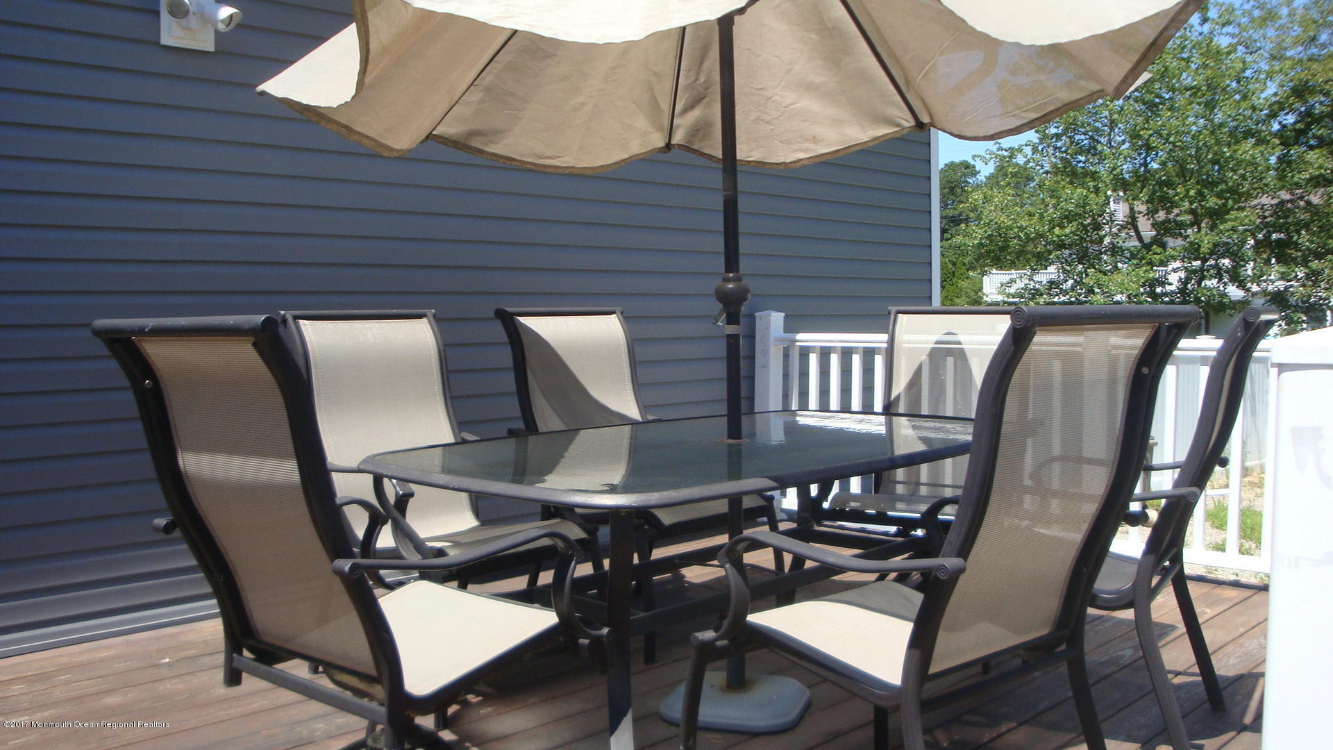 2323 Maple Road Forked River, NJ 08731 - Photo 23 of 23 a view of a patio with table and chairs with wooden floor