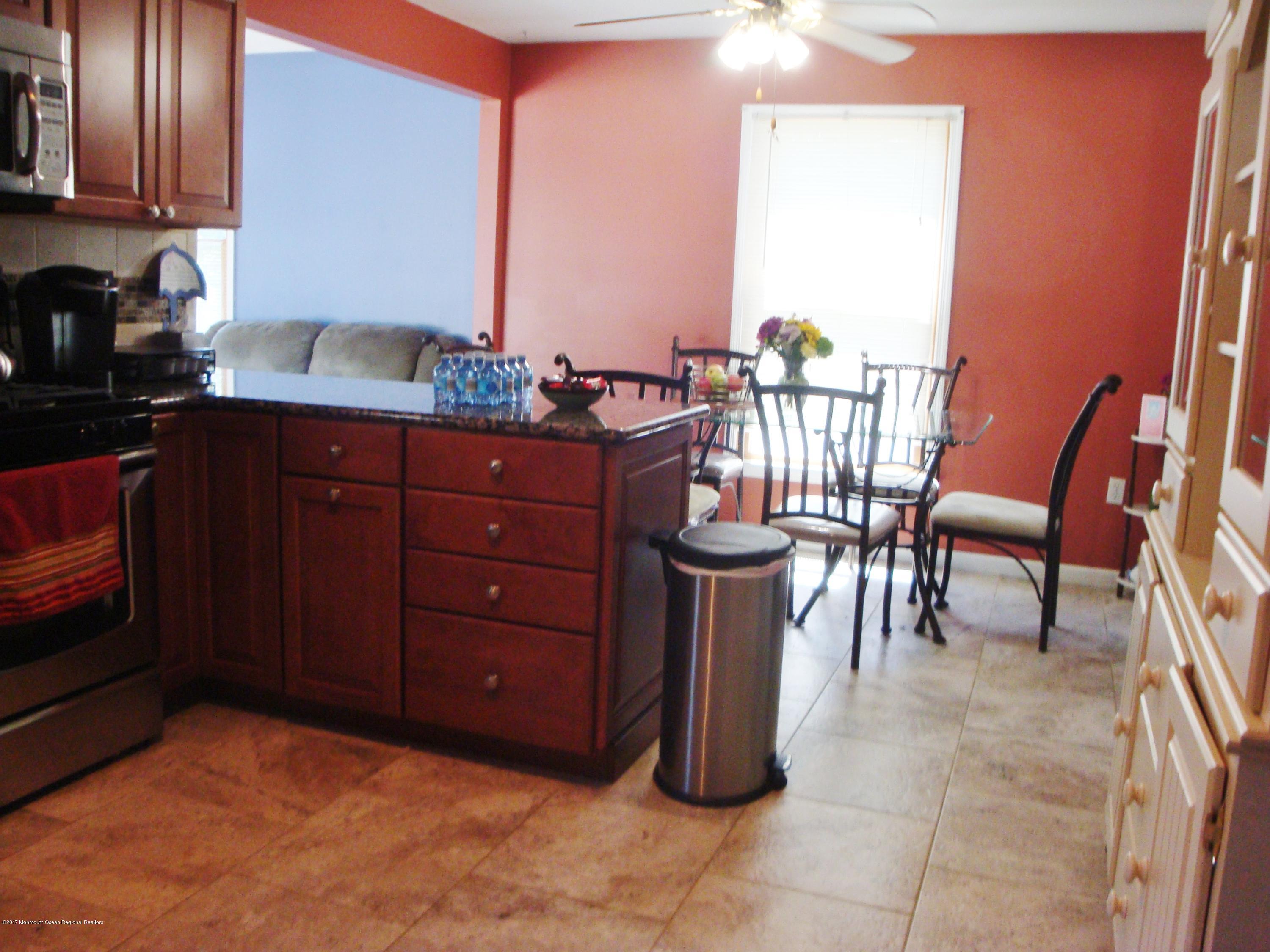 2323 Maple Road Forked River, NJ 08731 - Photo 3 of 23 a kitchen with a sink a table and chairs