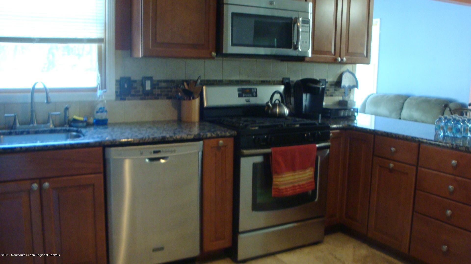 2323 Maple Road Forked River, NJ 08731 - Photo 4 of 23 a kitchen with granite countertop stainless steel appliances a stove microwave and sink