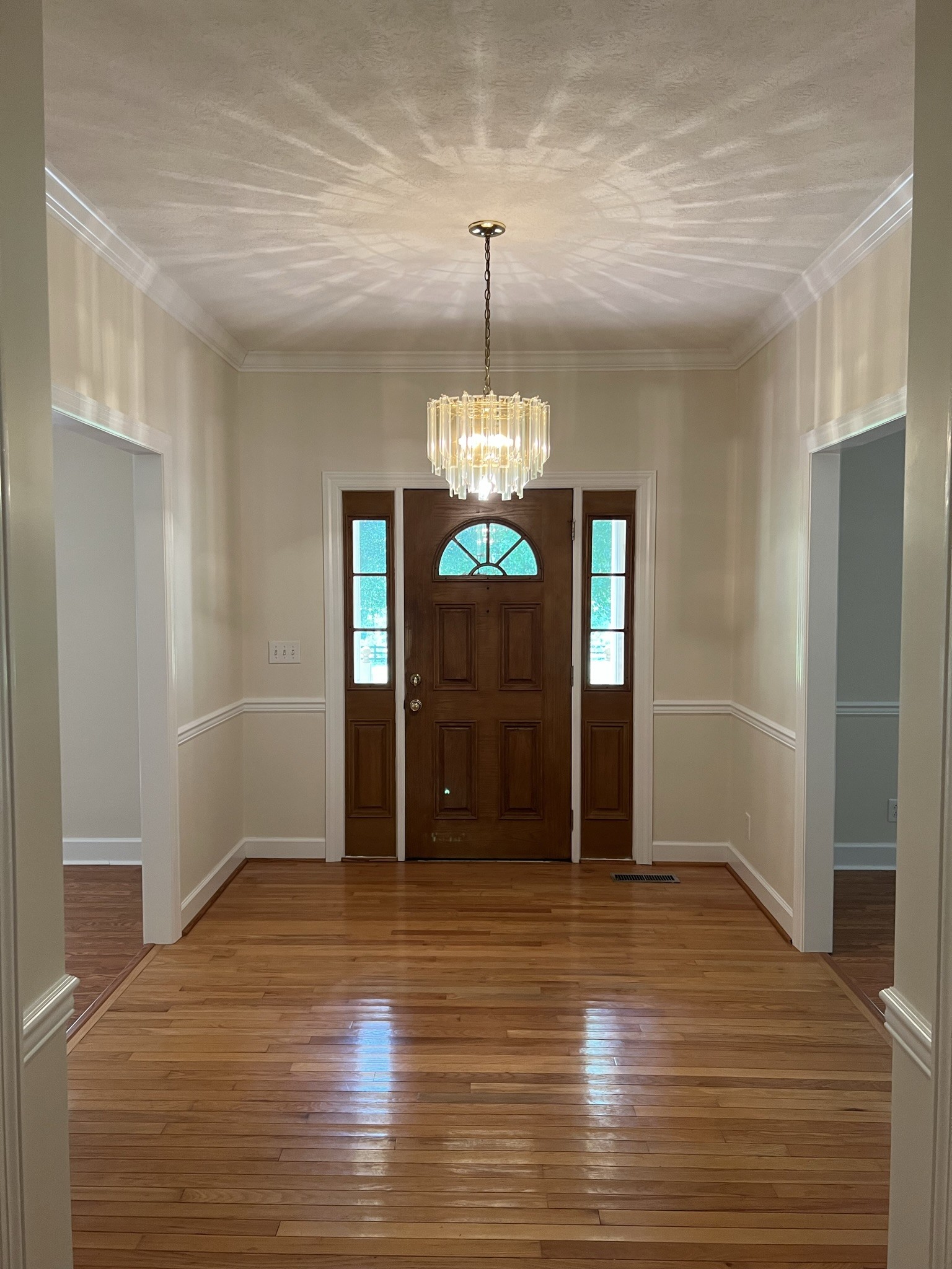 584 Corinth Road Portland, TN 37148 - Photo 17 of 42 a view of a hallway with wooden floor and chandelier