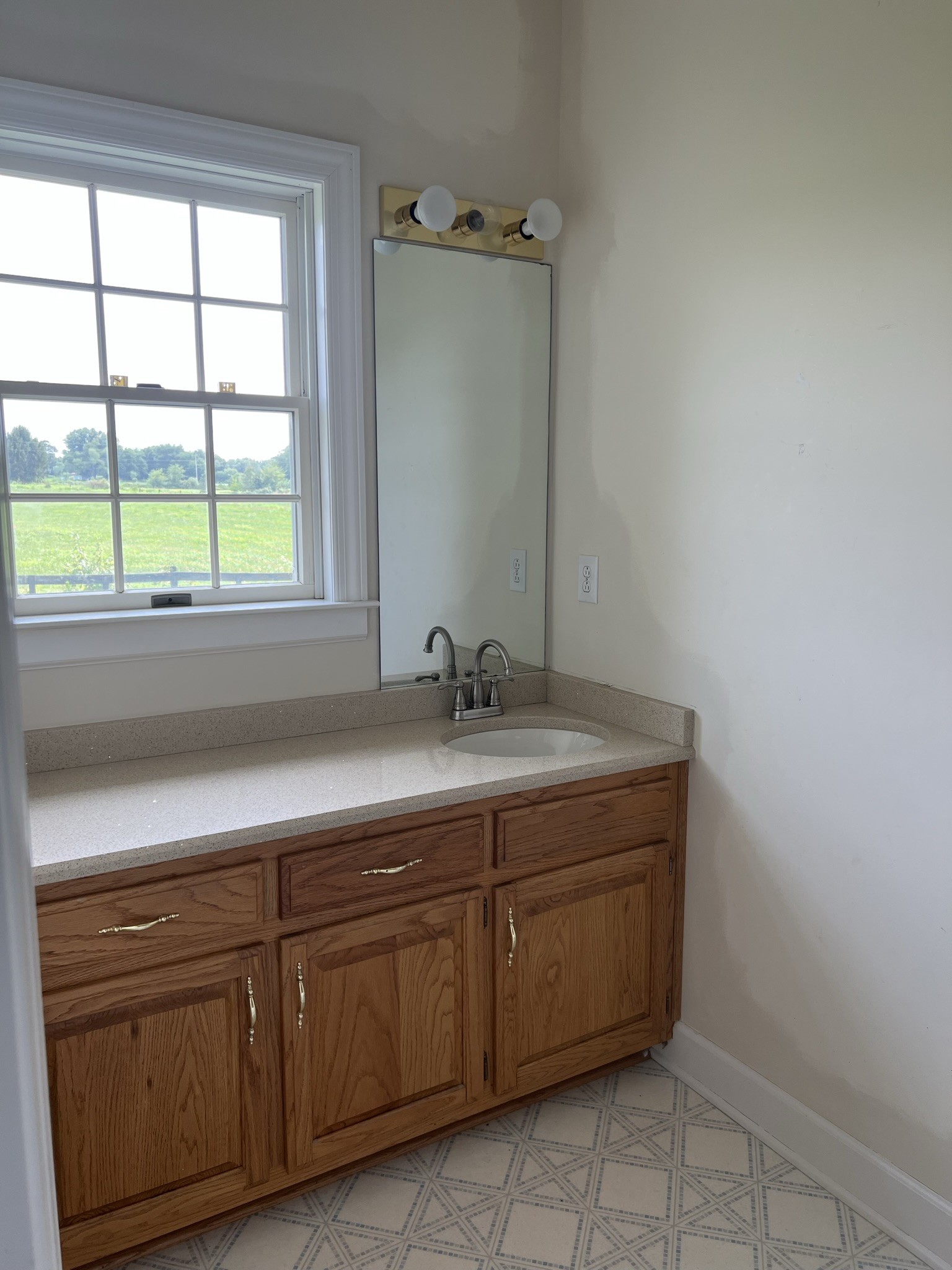 584 Corinth Road Portland, TN 37148 - Photo 23 of 42 a bathroom with a granite countertop sink and a window