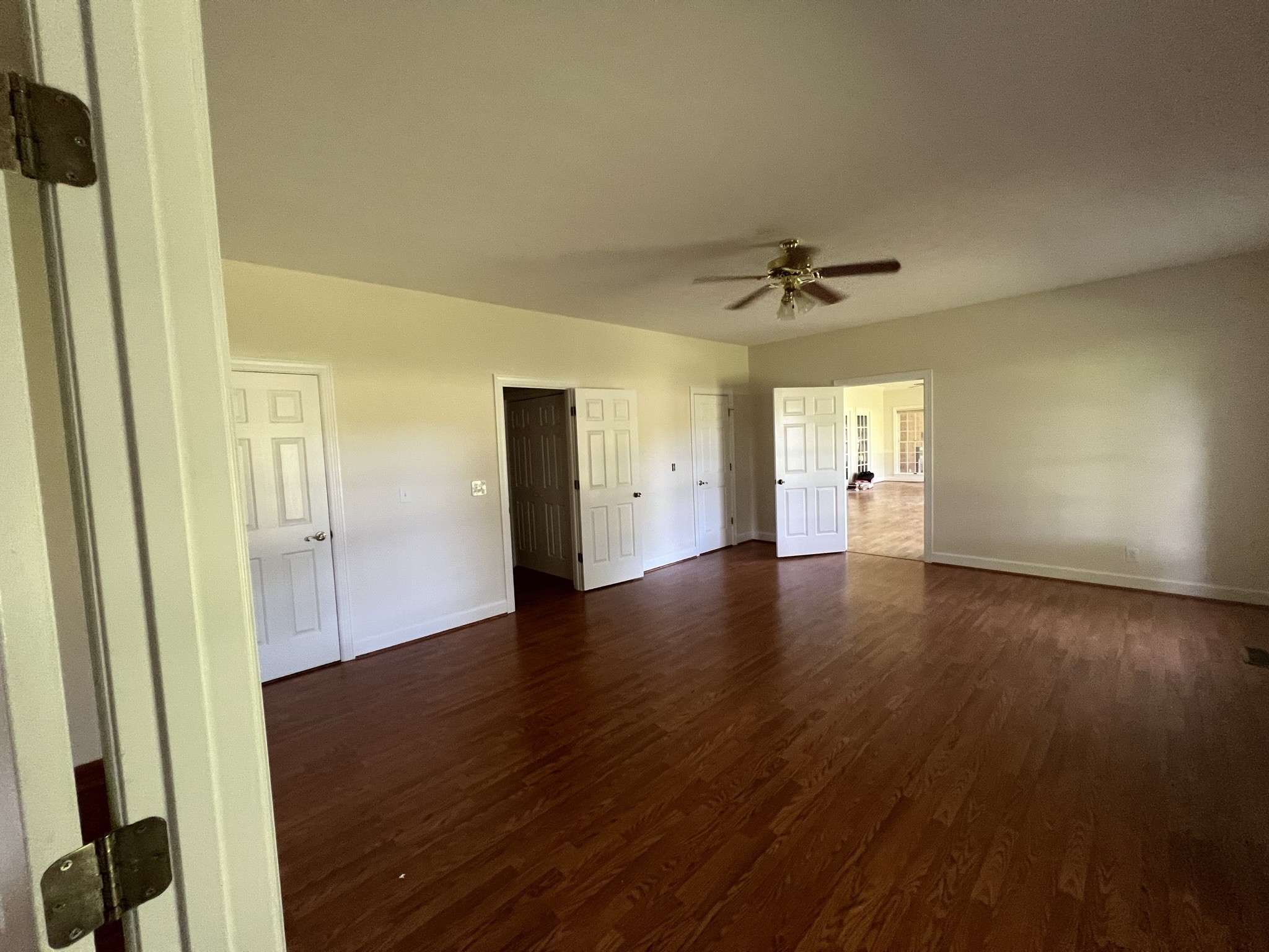 584 Corinth Road Portland, TN 37148 - Photo 32 of 42 an empty room with wooden floor and a ceiling fan