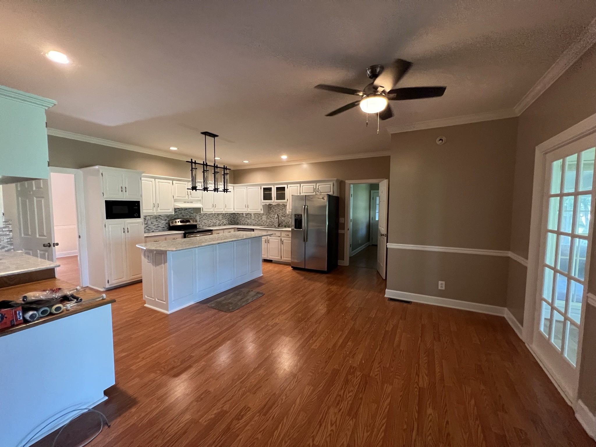 584 Corinth Road Portland, TN 37148 - Photo 38 of 42 a kitchen with stainless steel appliances kitchen island wooden floors and view living room