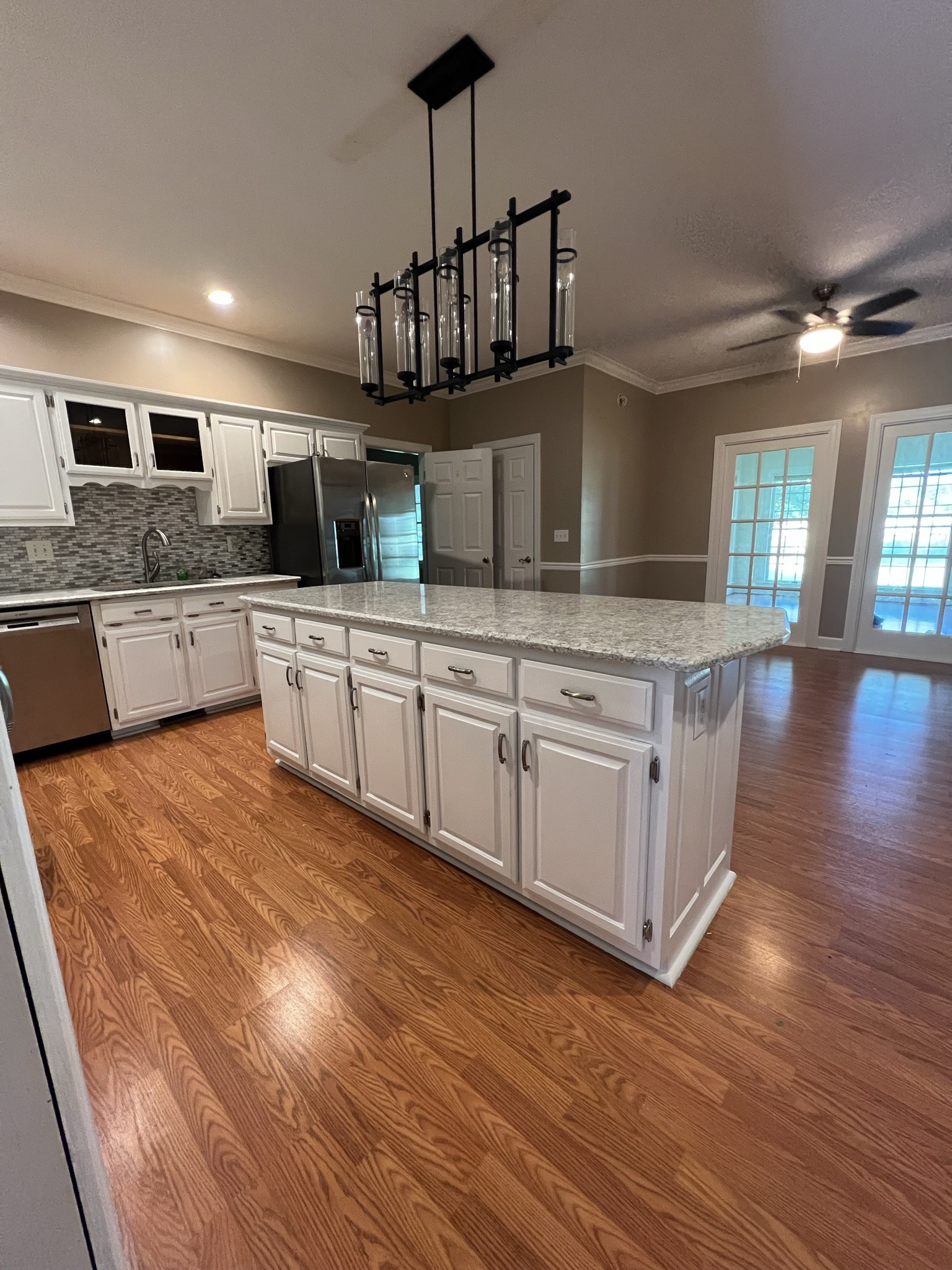 584 Corinth Road Portland, TN 37148 - Photo 42 of 42 a kitchen with stainless steel appliances granite countertop a stove top oven a sink dishwasher and white cabinets with wooden floor