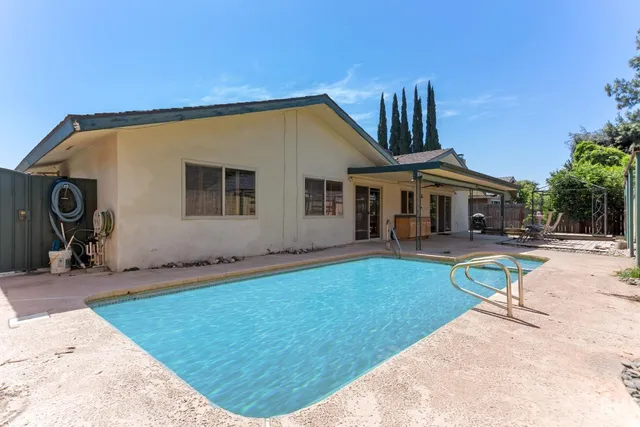 a view of a patio with table and chairs and potted plants