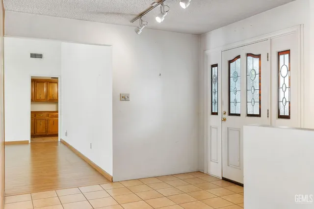 a view of a livingroom with wooden floor and kitchen space
