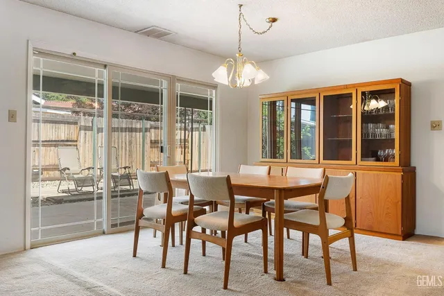 a dining room with furniture and a large window