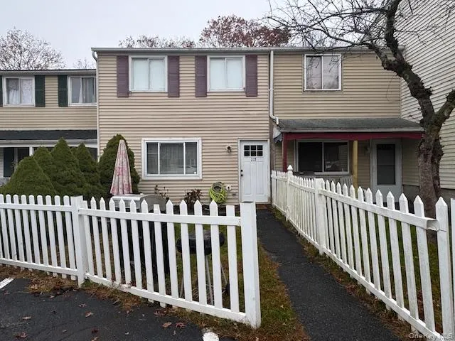 a view of a house with wooden fence
